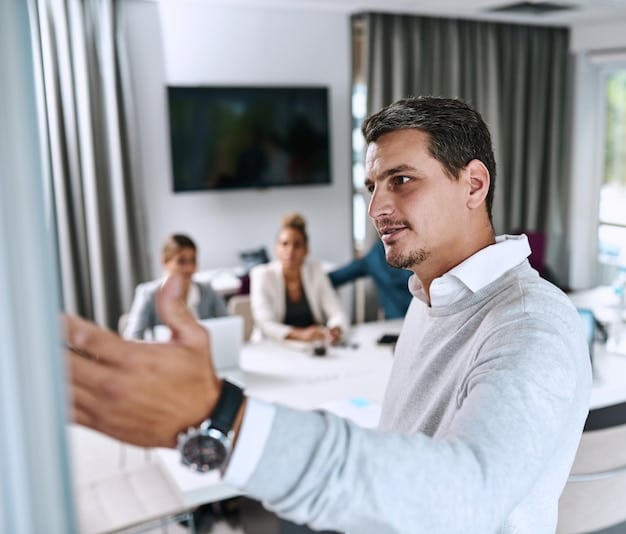 A Mexican executive leading a mindfulness session in a modern conference room. He is guiding his team through a meditation exercise with a calm and confident demeanor. Natural light fills the room, and the team members appear engaged and relaxed.