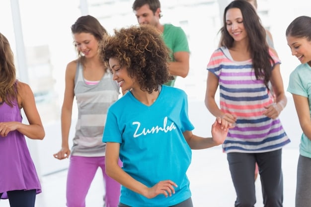 A diverse group of people are participating in a Zumba class in a brightly lit studio in Mexico. The instructor is energetic and smiling, leading the class through a dance routine. The participants are of varying ages and body types, all moving to the music and enjoying themselves.