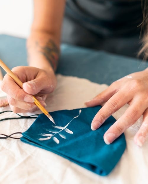 A close-up shot of hands sewing a t-shirt bag, highlighting the stitching and the texture of the fabric. Focus on the detail and craftsmanship involved.