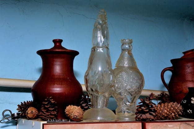 Several completed decorative lamps made from recycled glass bottles, each with unique designs and warm LED lighting, displayed on a mantelpiece in a cozy living room.