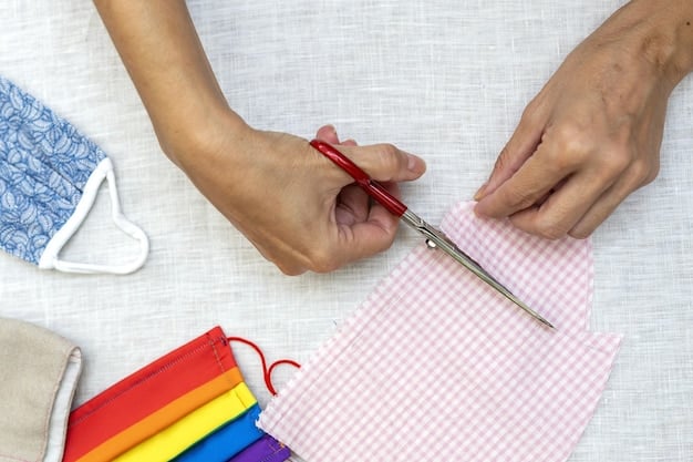An overhead shot of hands cutting colorful fabric with scissors on a cutting mat, surrounded by various sewing supplies and a printed doll pattern, emphasizing the initial stages of the rag doll making process.
