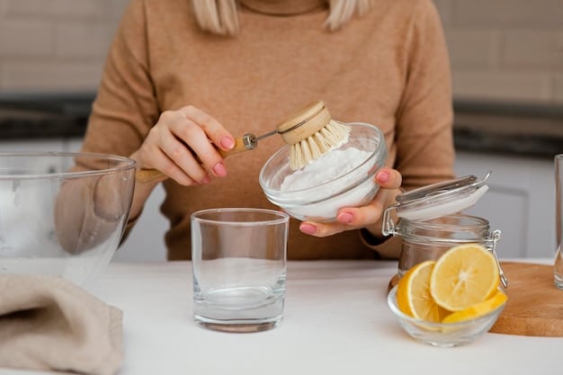 A person's hands mixing vinegar and baking soda in a glass bowl, with measuring spoons and ingredient containers nearby. The focus is on the mixing process and the common household items used. A clean, bright kitchen setting provides context.