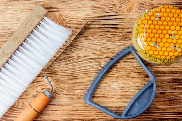 A collection of items needed for beeswax waterproofing: a bar of beeswax, a soft cloth, a brush, and a pair of clean leather shoes. The items are arranged on a wooden surface.