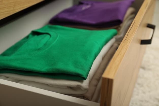 A close-up of a drawer with t-shirts folded vertically using the KonMari method. The drawer is neatly organized, with each t-shirt standing upright and visible. The lighting is soft and natural, highlighting the textures of the fabrics.