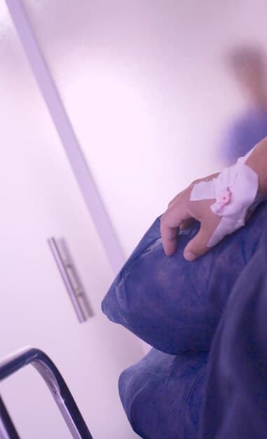 A slightly high-angle shot of a person's hands carefully wiping down the interior of a microwave with a clean, damp cloth. The microwave door is open, and light streams in, highlighting the surfaces being cleaned. The focus is on the hands and the cloth, conveying a sense of thoroughness and attention to detail.