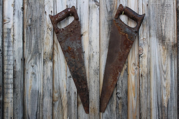 A split image showing a rusty tool before cleaning on one side and the same tool after being cleaned with vinegar and salt on the other side. The after side shows the tool looking clean and free of rust.