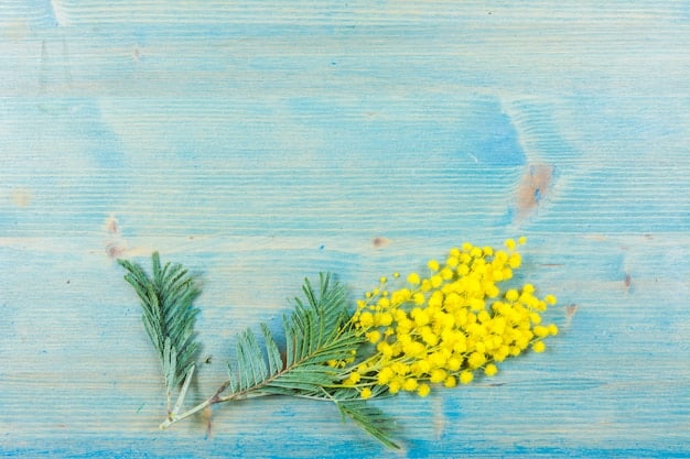 Aromatic eucalyptus leaves and bright yellow lemons arranged on a wooden cutting board, next to a glass bottle filled with essential oil. The scene is well-lit, emphasizing the natural textures and colors of the ingredients.